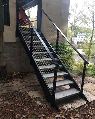 Custom metal staircase design with intricate details and a polished finish